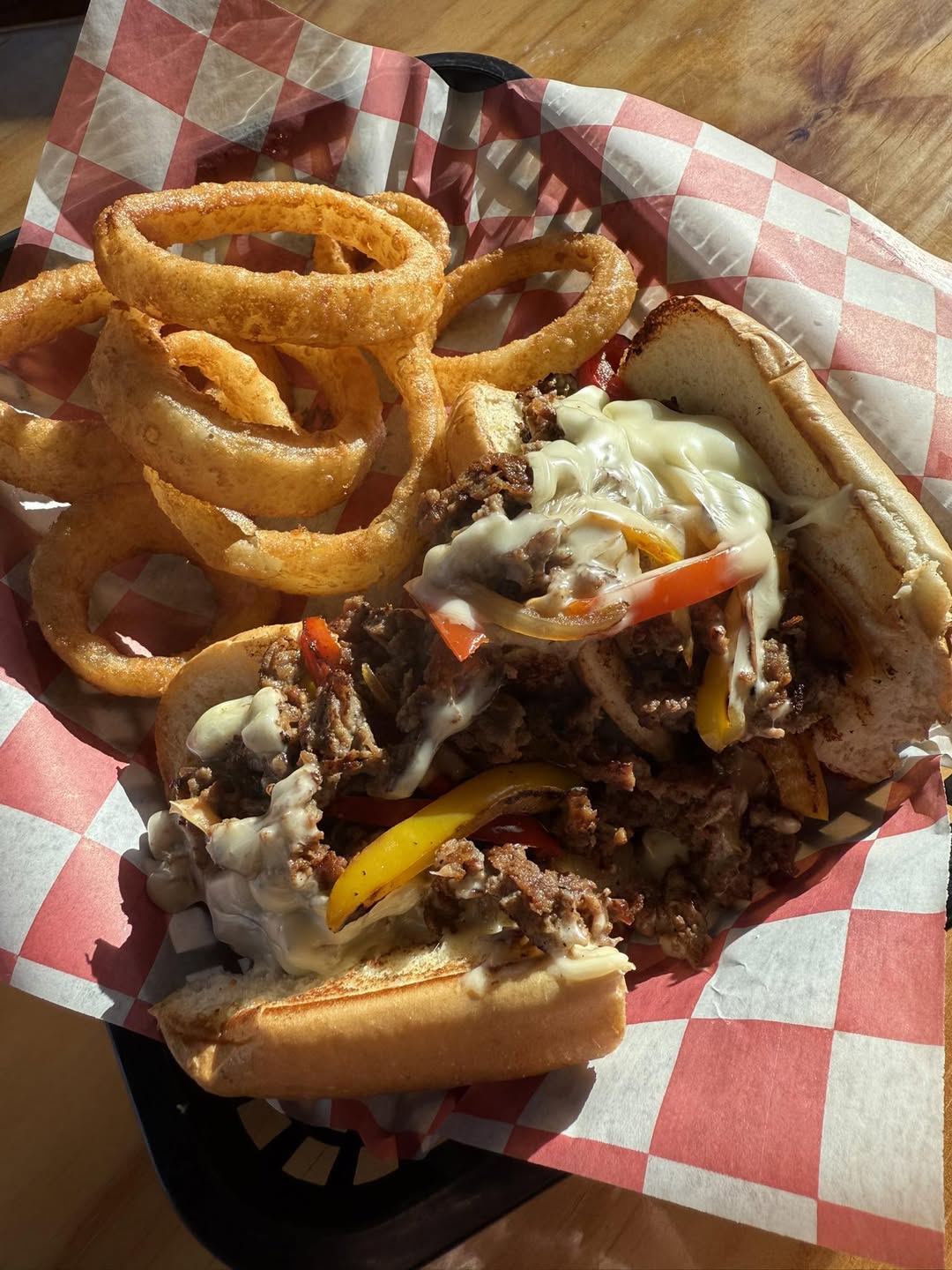 Philly cheesesteak — peppers, onions and melted cheese on a hoagie