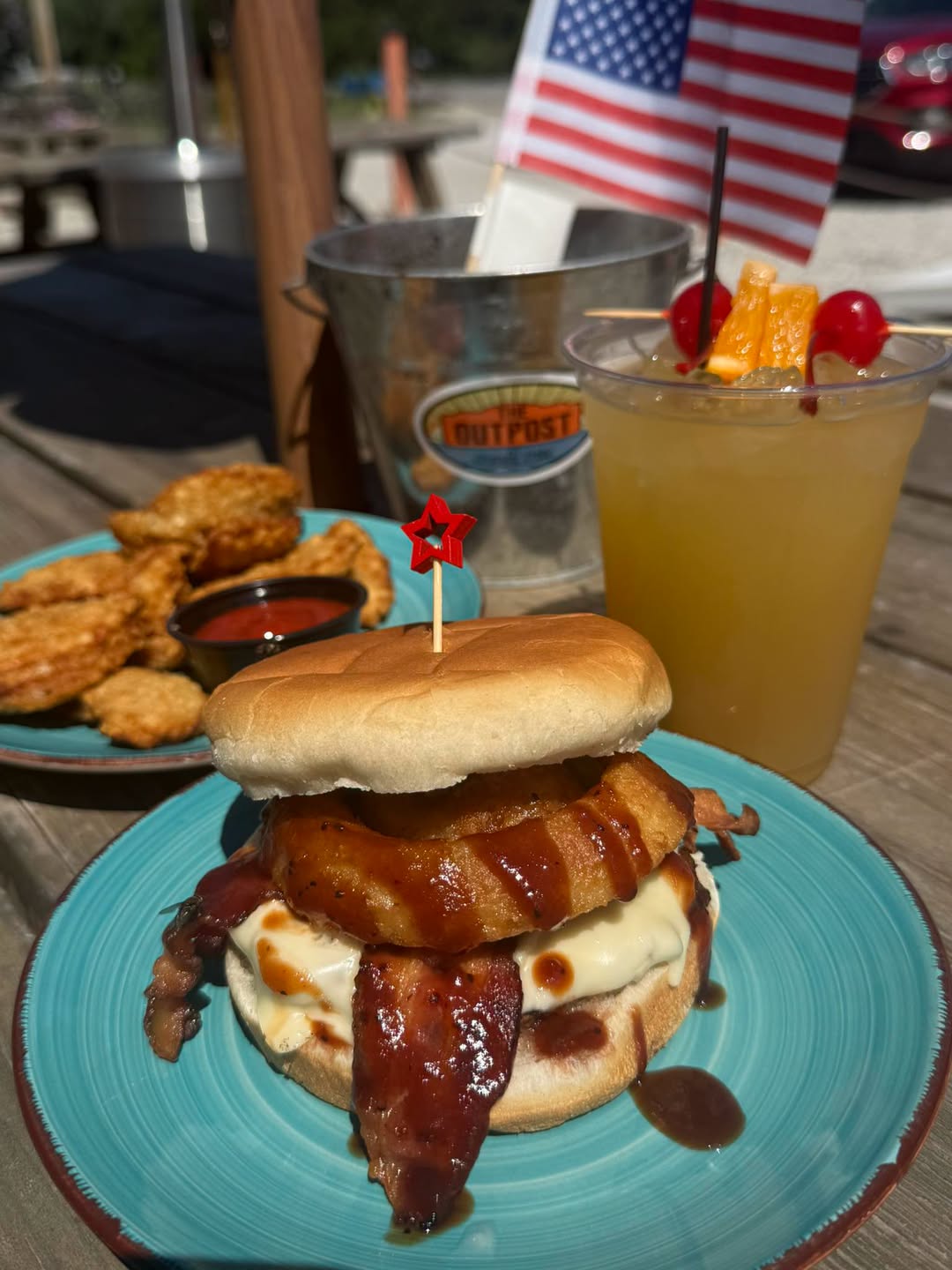 Rodeo burger — hand-pattied burger with bacon, cheese, crispy onion ring and a sweet BBQ drizzle