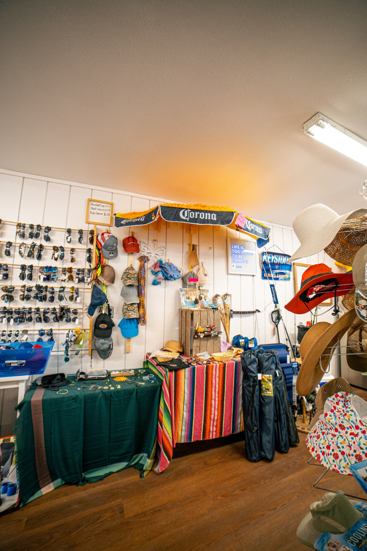 Sunglasses, hats and beach gear display inside the store