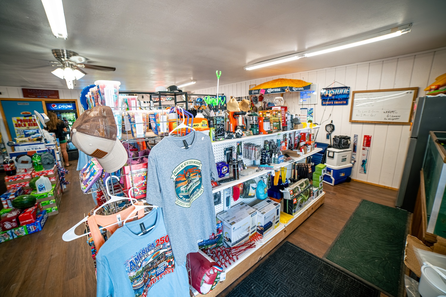 Shelves of fishing tackle, camping gear and Outpost tees